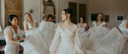 Bride and Bridesmaids holding her dress